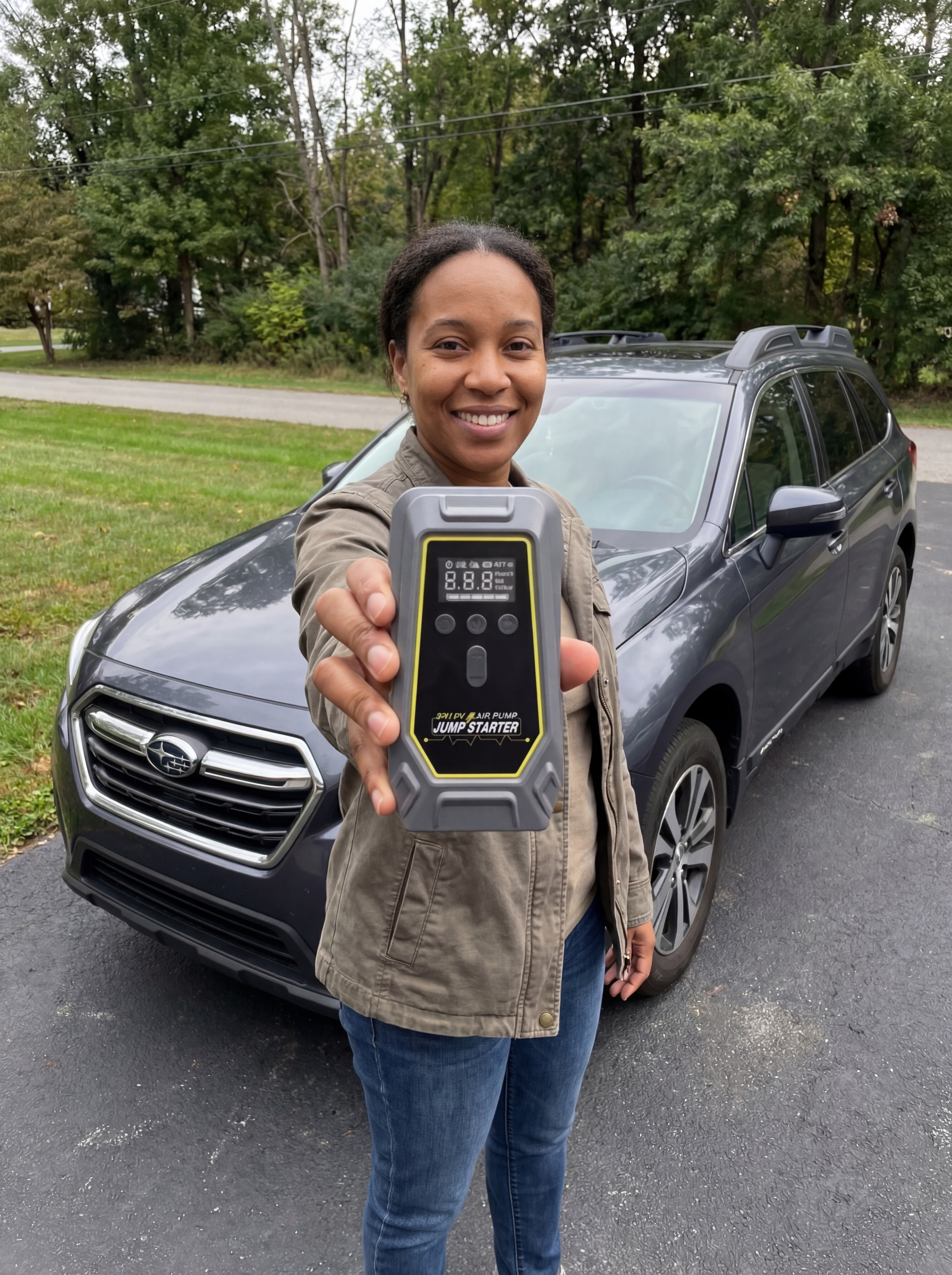 Person holding RoadKit device next to car